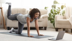 woman using CBD for energy and exercising in front of her laptop