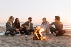 Friends on the beach with a fire