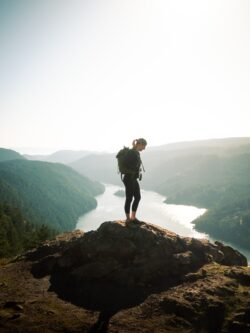 woman standing on peak in nature