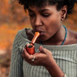 woman smoking a bowl of cannabis