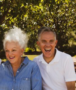 two older people laughing